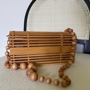 CULT GAIA wooden bamboo cage clutch with beaded strap